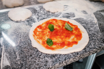 The process of making pizza. Cook prepares pizza.