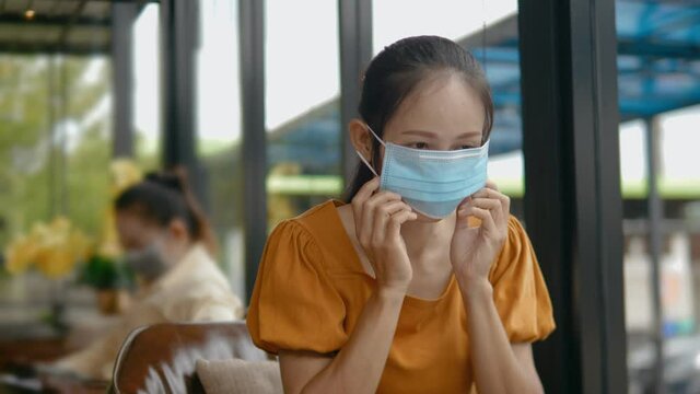 New normal Asian wearing an anti virus protection mask to prevent others from corona COVID-19. People travel under COVID-19 restrictions. Social distancing rules in practice.