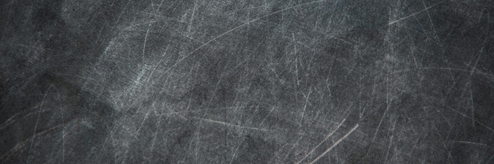 back to school: black chalkboard with blurry traces of white chalk and crayons, minor scratches