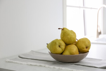 Fresh ripe pears on countertop in kitchen