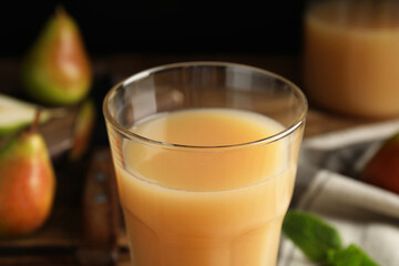 Fresh pear juice in glass, closeup view