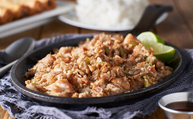 filipino food - pork sisig in cast iron pan