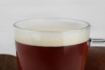 Glass of delicious kvass on blurred background, closeup