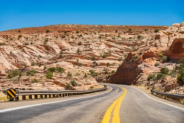 Fototapete Route 66 Landscape with rocks, sunny sky with clouds and beautiful asphalt road in the evening in summer.  © Volodymyr