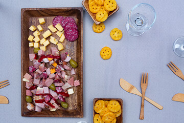 
food prepared with cheeses and cold cuts on a wooden tray and wicker to enjoy with the family