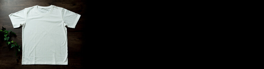 White t-shirt on a black board. 黒い板の上の白いtシャツ