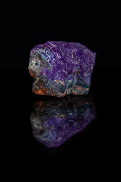 Sugilite violet Kalahari stone on black background