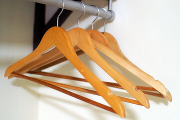 a group of wooden clothes hanger with hangers