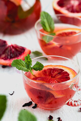 Hibiscus Tea Garnished with Blood Orange and Mint-in clear glass tea cups top view