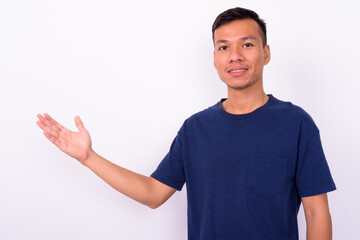 Fototapeta premium Portrait of happy young Asian man with beard stubble