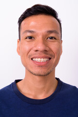 Portrait of happy young Asian man with beard stubble