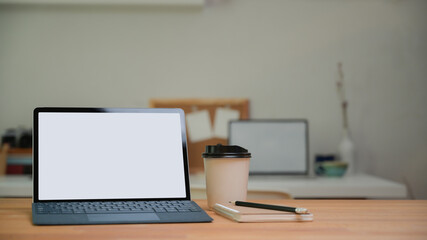 Workspace with laptop, schedule book and paper cup  on wooden table, clipping path.