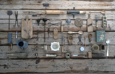 NOSTALGICAL PICTURE OF OLD KITCHEN UTENSILS ORDERED ON A WOODEN TABLE. TOP VIEW
