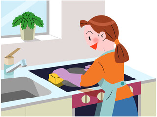 システムキッチンを清掃する女性