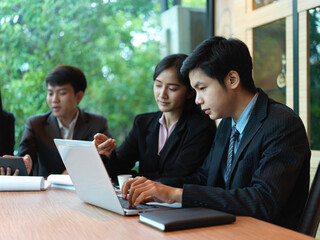 Portrait of office workers brainstorming on their project in meeting room