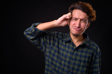Portrait of young Asian hipster man with curly hair