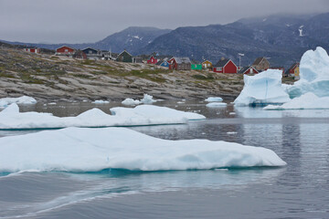 Colorful houses in Rodebay (Oqatsut), set on a hill overlooking iceberg-dotted Disko Bay, West...