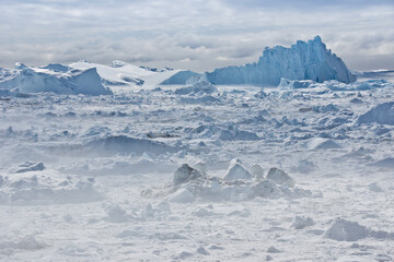 Icebergs piled up in the icefiord, calved from Sermeq Kujalleq glacier, Ilullisat, Disko Bay, West...