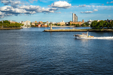 Beautiful sunset with clouds and boat speeding and lighthouse