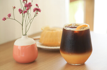 Americano iced coffee mixed with orange serving in home for healthy drinking 