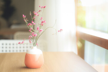 small flower vase  on wooden table  in home 