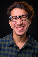 Portrait of happy young Asian hipster man with curly hair