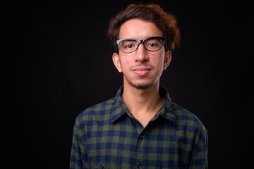 Portrait of young Asian hipster man with curly hair