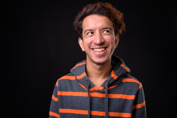 Portrait of happy young Asian man with curly hair