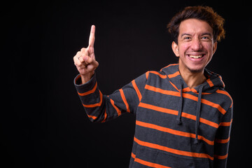 Portrait of happy young Asian man with curly hair