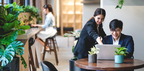 Group of professional business discussing meeting strategy sharing ideas thoughts with project.Creative business people working with laptop computer in green plant terrace decorated modern workloft