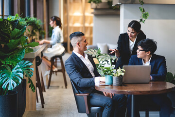 Group of professional business discussing meeting strategy sharing ideas thoughts with project.Creative business people working with laptop computer in green plant terrace decorated modern workloft