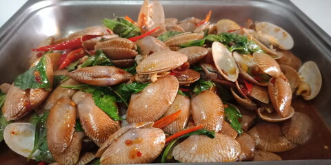 Stir-Fried Clams with Green Basil Vegetables are herbs, spicy Thai food, delicious and useful appetizer.