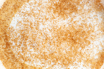 Foam of coffee with cinnamon close-up, top view