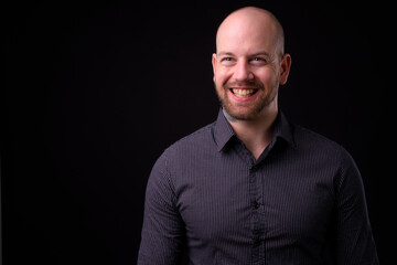 Obraz premium Portrait of happy handsome bald bearded businessman