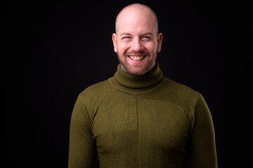 Portrait of happy handsome bald bearded man