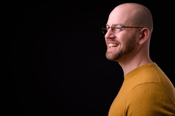 Portrait of happy handsome bald bearded man