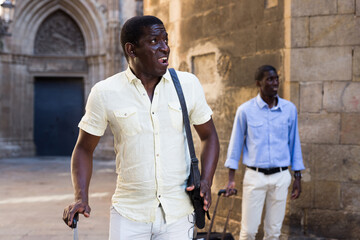 Fototapeta na wymiar Two african american tourists visiting the sights of the old uropean city