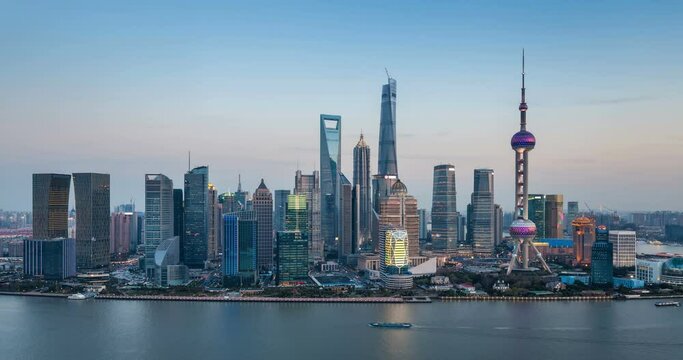 shanghai skyline in nightfall, time lapse of beautiful pudong financial center and huangpu river at dusk to night, China.