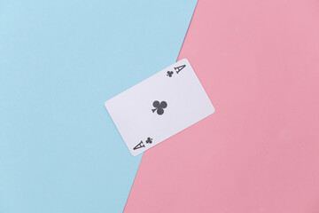 Ace of clubs on pink blue background. Top view. Flat lay