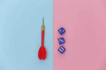 Dice and darts on pink blue pastel background. Top view. Minimalism