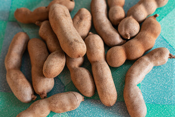 Thai fruit tamarind, brown pod with pulp inside, Indian date. Selective focus