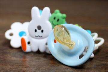 blue orthodontic pacifier on purple cloth