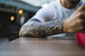 Selective focus shot of a male's forearm tattoo