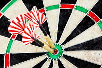 three darts in bull's eye close up. red three darts arrows in the target center business goal concept