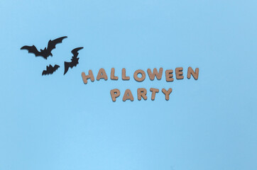 Bats on blue background with the word Halloween party. Halloween theme. Top view