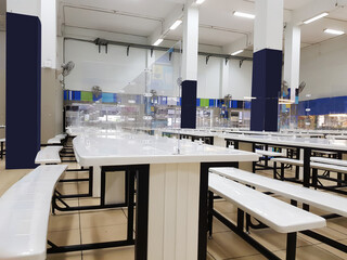A canteen with sneeze guard (keeping distance protect spreading of germs and virus) 