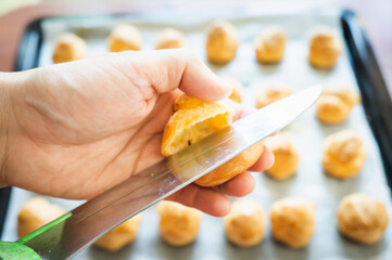Cutting cream puff by knife 