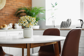 Dining table in interior of modern kitchen