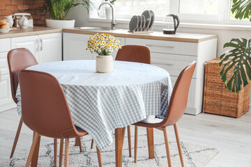 Dining table in interior of modern kitchen