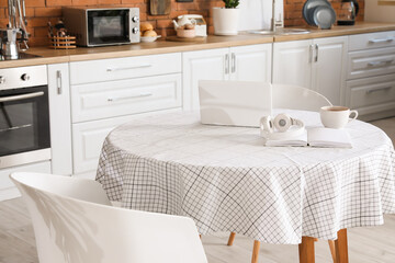 Dining table in interior of modern kitchen